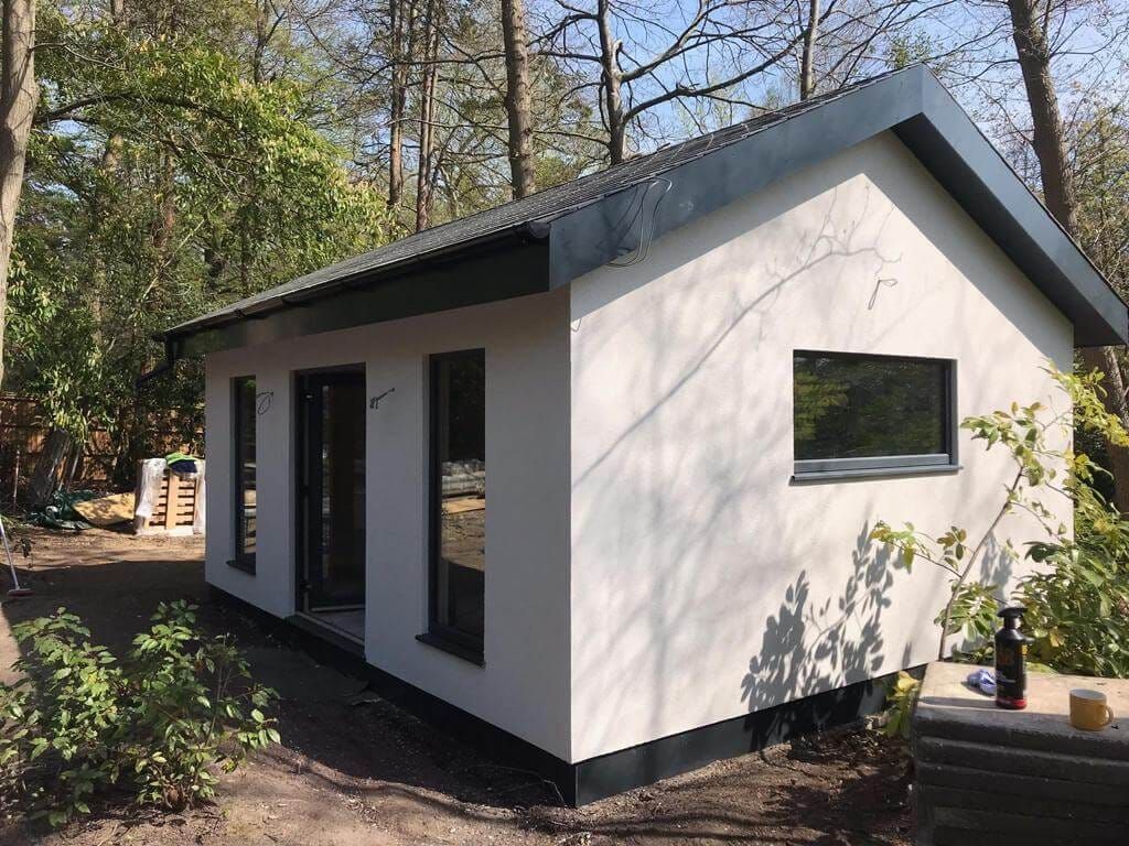 Rendered Modulux modular home with a pitched roof and full-height windows